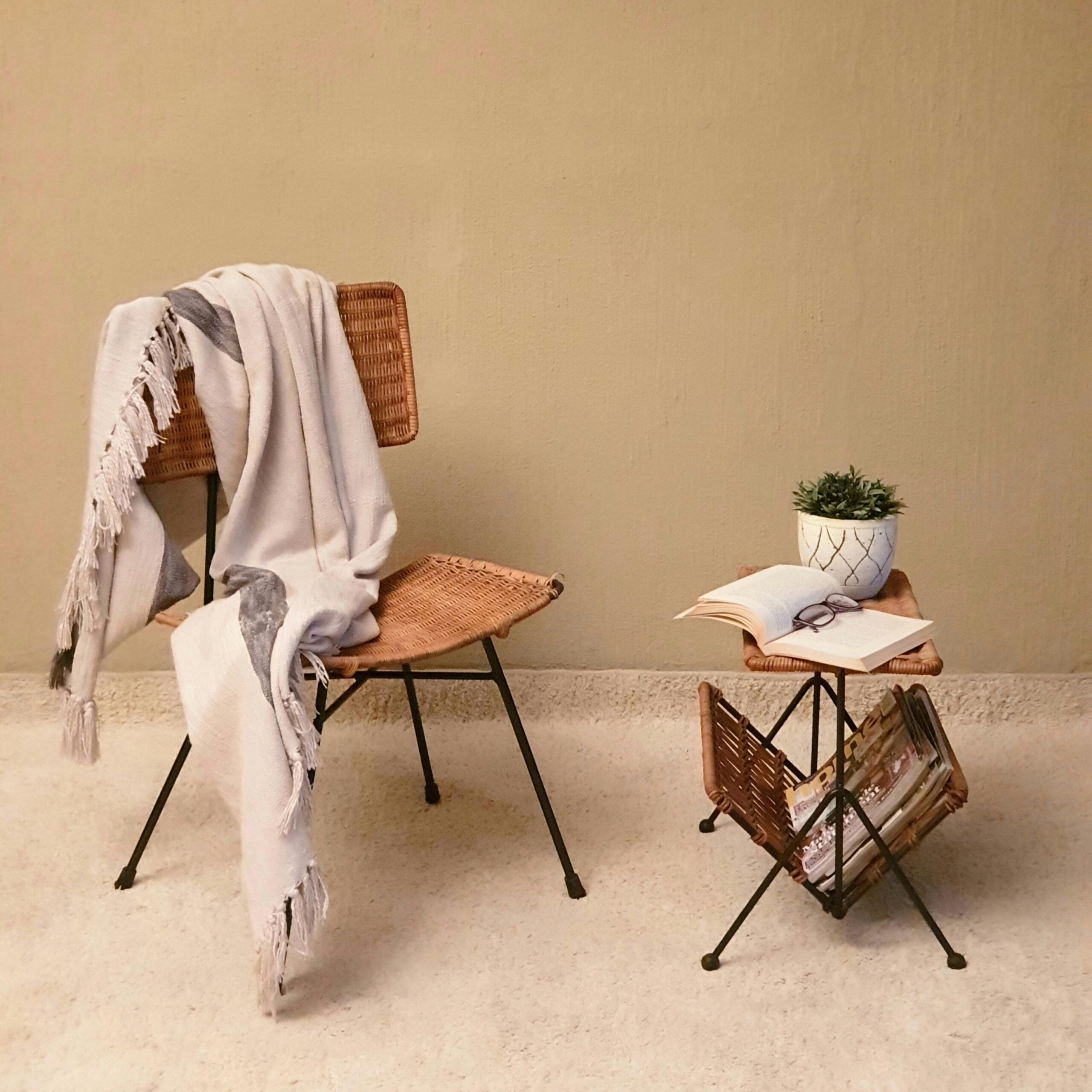 the image shows a chair and table with descripting a cozy corner of a home with books